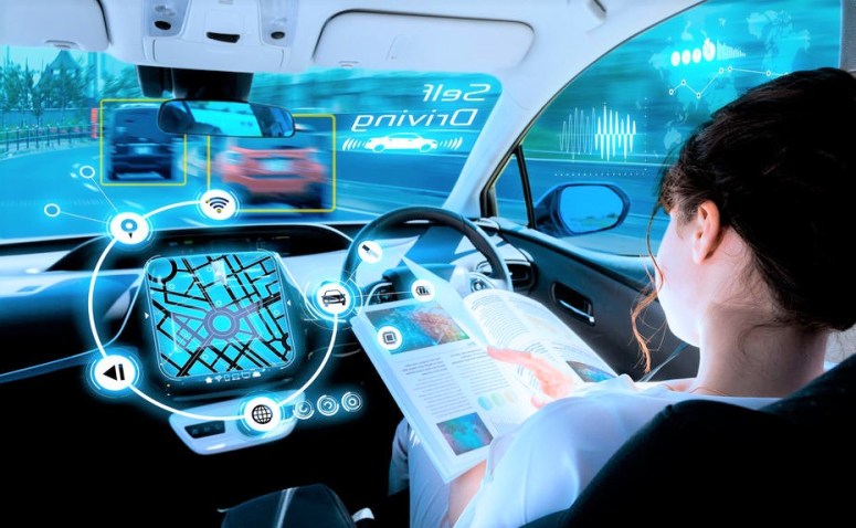 young-woman-reading-a-magazine-in-a-autonomous-car-driverless-car-selfdriving-vehicle-heads-up-display-automotive-technology.jpg